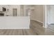 Bright kitchen features modern appliances, white cabinetry, and an eat-in island overlooking the living area at 19540 Glen Elm Way, Orlando, FL 32833