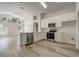 Bright open-concept kitchen featuring stainless steel appliances, white cabinets and a large window at 19540 Glen Elm Way, Orlando, FL 32833