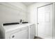 Clean laundry area with a modern washer, dryer, and overhead wire shelving at 19540 Glen Elm Way, Orlando, FL 32833