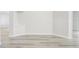 Open-concept living area with white walls, laminate flooring, and neutral decor at 19540 Glen Elm Way, Orlando, FL 32833