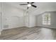 Spacious and bright living room featuring vaulted ceilings, large windows, and modern wood-look flooring at 19540 Glen Elm Way, Orlando, FL 32833