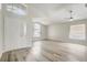 Bright living room featuring light wood-look floors, high ceilings, and abundant natural light at 19540 Glen Elm Way, Orlando, FL 32833
