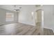 Airy open-concept living room offers modern flooring, neutral walls, and seamless flow to other areas at 19540 Glen Elm Way, Orlando, FL 32833
