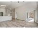 Open-concept living room that features laminate flooring and access to the rear patio at 19540 Glen Elm Way, Orlando, FL 32833