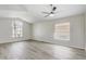Bright primary bedroom featuring neutral walls, wood-look floors, and large windows offering ample natural light at 19540 Glen Elm Way, Orlando, FL 32833