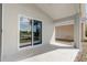Covered back patio with views of the green backyard and a nearby lake at 19540 Glen Elm Way, Orlando, FL 32833