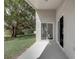 Covered patio featuring neutral colors and a sliding glass door that leads to the yard at 19540 Glen Elm Way, Orlando, FL 32833