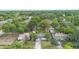 High-angle aerial shot of the property featuring a home in a neighborhood with dense tree cover, offering privacy at 2123 Weber St, Orlando, FL 32803