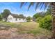 Exterior shot of the home's backyard, showcasing the lawn, exterior siding, and partial view of the surroundings at 2123 Weber St, Orlando, FL 32803