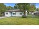 Front exterior showing the home's facade, manicured lawn, driveway, and established landscaping for a welcoming curb appeal at 2123 Weber St, Orlando, FL 32803