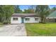 Charming single-story home with a well-maintained lawn, a paved driveway, and a pleasing curb appeal at 2123 Weber St, Orlando, FL 32803