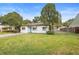 Attractive home showcasing a neat lawn, classic white exterior, and established trees at 2123 Weber St, Orlando, FL 32803