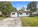 Charming single-story home with a well-maintained lawn, blue door, and mature trees at 2123 Weber St, Orlando, FL 32803