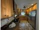 Well-equipped kitchen featuring wood cabinets, modern fixtures, and tiled backsplash at 2123 Weber St, Orlando, FL 32803