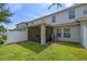 A fenced backyard featuring a screened lanai and green grass at 2447 Hassonite St, Kissimmee, FL 34744