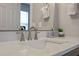 Close-up of bathroom featuring clean white countertop, sleek silver faucet, and modern decor at 2447 Hassonite St, Kissimmee, FL 34744