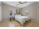 Cozy bedroom featuring a ceiling fan, picture, and two windows providing natural light at 2447 Hassonite St, Kissimmee, FL 34744