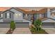 Charming townhouse with attached garages, landscaped yard, neutral paint and appealing architectural details at 2447 Hassonite St, Kissimmee, FL 34744
