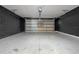 Spacious two-car garage with a gray painted brick accent wall at 2447 Hassonite St, Kissimmee, FL 34744