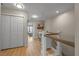 Upstairs hallway boasts wood floors, white trim, storage closet, and open feel at 2447 Hassonite St, Kissimmee, FL 34744