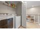 Convenient laundry room with modern appliances, storage shelves, and bright, clean space for efficient chores at 2447 Hassonite St, Kissimmee, FL 34744