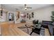 Cozy living room with hardwood floors, contemporary furnishings and decor, and a ceiling fan at 2447 Hassonite St, Kissimmee, FL 34744
