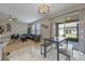 Open-concept living room features modern furnishings, sleek lighting, and seamless access to outdoor patio with marble floors at 2447 Hassonite St, Kissimmee, FL 34744