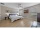 Serene bedroom featuring hardwood floors, neutral walls, a ceiling fan and bright windows at 2447 Hassonite St, Kissimmee, FL 34744