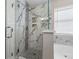 Modern bathroom showcasing luxurious walk-in shower with marble tile and glass enclosure at 2447 Hassonite St, Kissimmee, FL 34744
