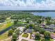 Gorgeous aerial view of a waterfront home with a lush landscape and private dock on a sunny day at 2491 Island Dr, Longwood, FL 32779