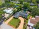 Overhead shot of a lovely home boasting a pool, brick driveway, landscaping, and a well-maintained lawn at 2491 Island Dr, Longwood, FL 32779