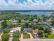 A stunning aerial view of a waterfront home with pool, beautiful greenery and clear blue skies at 2491 Island Dr, Longwood, FL 32779