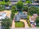 Aerial view of home with a pool, lush greenery, and a beautiful brick driveway at 2491 Island Dr, Longwood, FL 32779