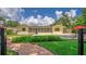 Inviting backyard with a beautiful brick patio, screened porch, sparkling pool, and lush landscaping at 2491 Island Dr, Longwood, FL 32779