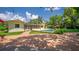 Inviting backyard with a beautiful brick patio, screened porch, sparkling pool, and lush landscaping at 2491 Island Dr, Longwood, FL 32779