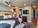 Cozy bedroom with neutral tones, a ceiling fan, and a view into the en-suite bathroom at 2491 Island Dr, Longwood, FL 32779