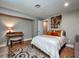 Bedroom featuring a bed, desk, and a door leading to another room at 2491 Island Dr, Longwood, FL 32779