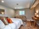 Neutral bedroom with a comfortable bed, seating area, and parquet flooring at 2491 Island Dr, Longwood, FL 32779