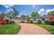 Charming home with a brick driveway, lush landscaping, and inviting front entrance, showcasing curb appeal at 2491 Island Dr, Longwood, FL 32779