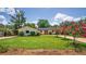 Charming single-story home with a well-manicured lawn, inviting curb appeal, and pink flowering trees at 2491 Island Dr, Longwood, FL 32779