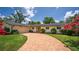 Charming single-story home with brick driveway, lush lawn, and blooming crape myrtle trees at 2491 Island Dr, Longwood, FL 32779