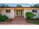 Inviting front entrance with a decorative green door and brick paver steps at 2491 Island Dr, Longwood, FL 32779