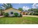Front view of home with landscaped lawn, featuring brick driveway and blooming flowers, adding charm at 2491 Island Dr, Longwood, FL 32779
