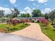 Charming front yard featuring a curved driveway and colorful landscaping, enhancing the home's curb appeal at 2491 Island Dr, Longwood, FL 32779