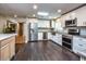 Bright kitchen with white cabinets, stainless steel appliances, and dark wood floors at 2491 Island Dr, Longwood, FL 32779