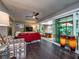 Stylish living room with dark wood floors and seamless access to the sunroom at 2491 Island Dr, Longwood, FL 32779