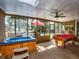 Relaxing sunroom with hot tub, billiards table and view of the backyard at 2491 Island Dr, Longwood, FL 32779