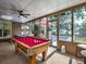 Inviting sunroom featuring a pool table, hot tub and views of the pool area at 2491 Island Dr, Longwood, FL 32779