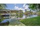 Lush waterfront featuring a covered dock, perfect for boating and enjoying peaceful water views at 2491 Island Dr, Longwood, FL 32779