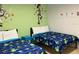 Playful bedroom with twin beds, cartoon-themed decor, and ample space for a imagination at 2660 Santosh Cv, Kissimmee, FL 34746